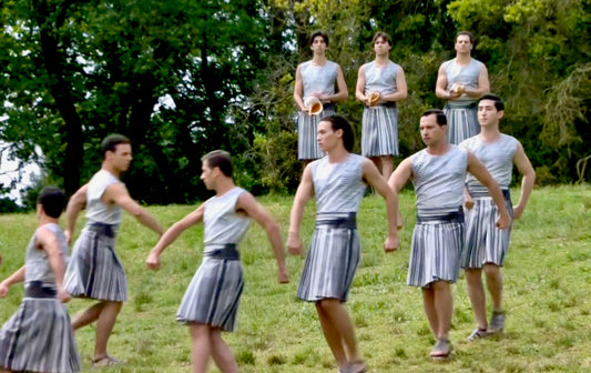 Men in skirts at the 2024 Olympic flame lighting