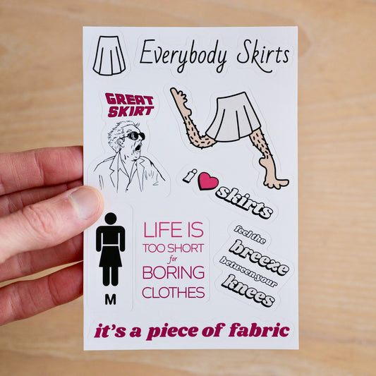 A hand holding a 4x6 sticker sheet with 9 stickers: a white skirt with black outline, 'Everybody Skirts' in logo text, 'Great Skirt' doc brown in amazement, hairy legs with big feet prancing in a light grey skirt, i <3 skirts, a men's washroom symbol with skirt instead of pants and an 'M' below it, 'Life is too short for boring clothes in all caps, 'feel the breeze between your knees'. and 'it's a piece of fabric'.